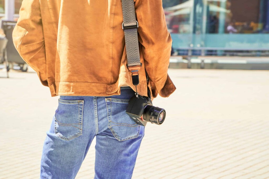 The Freedom Of Solo Travel: A Young Tourist With Camera Seeking The New City After Arrival