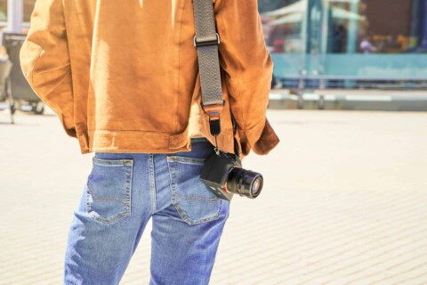 The Freedom Of Solo Travel: A Young Tourist With Camera Seeking The New City After Arrival