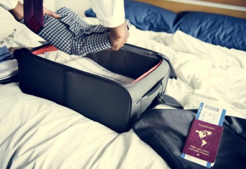 A man preparing his suitcase for travel
