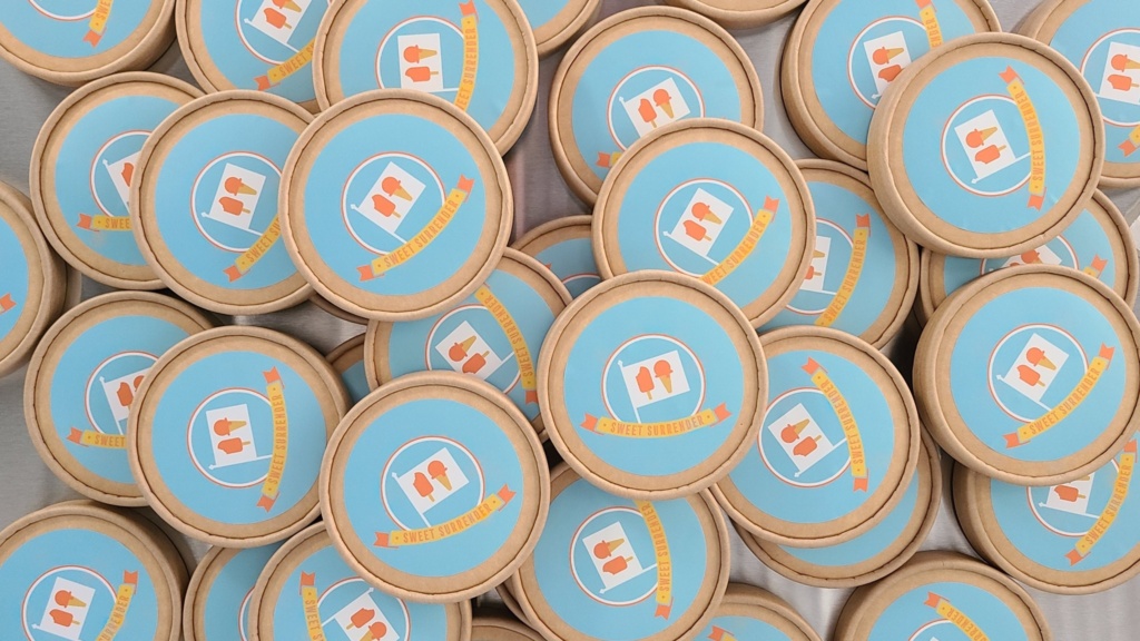 a collection of gelato containers with sweet surrender gelato labels
